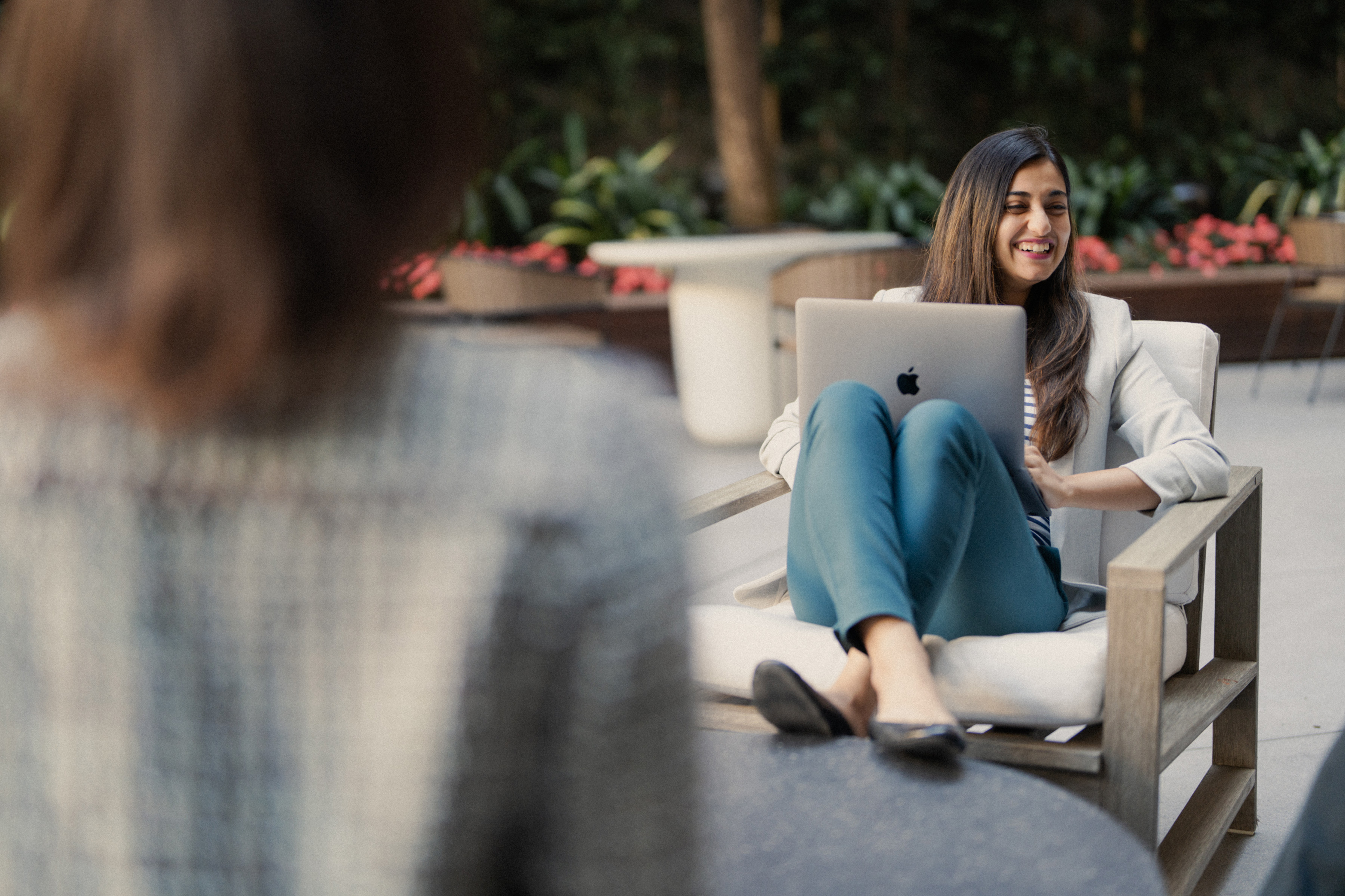 Women in a chair outside with a computer